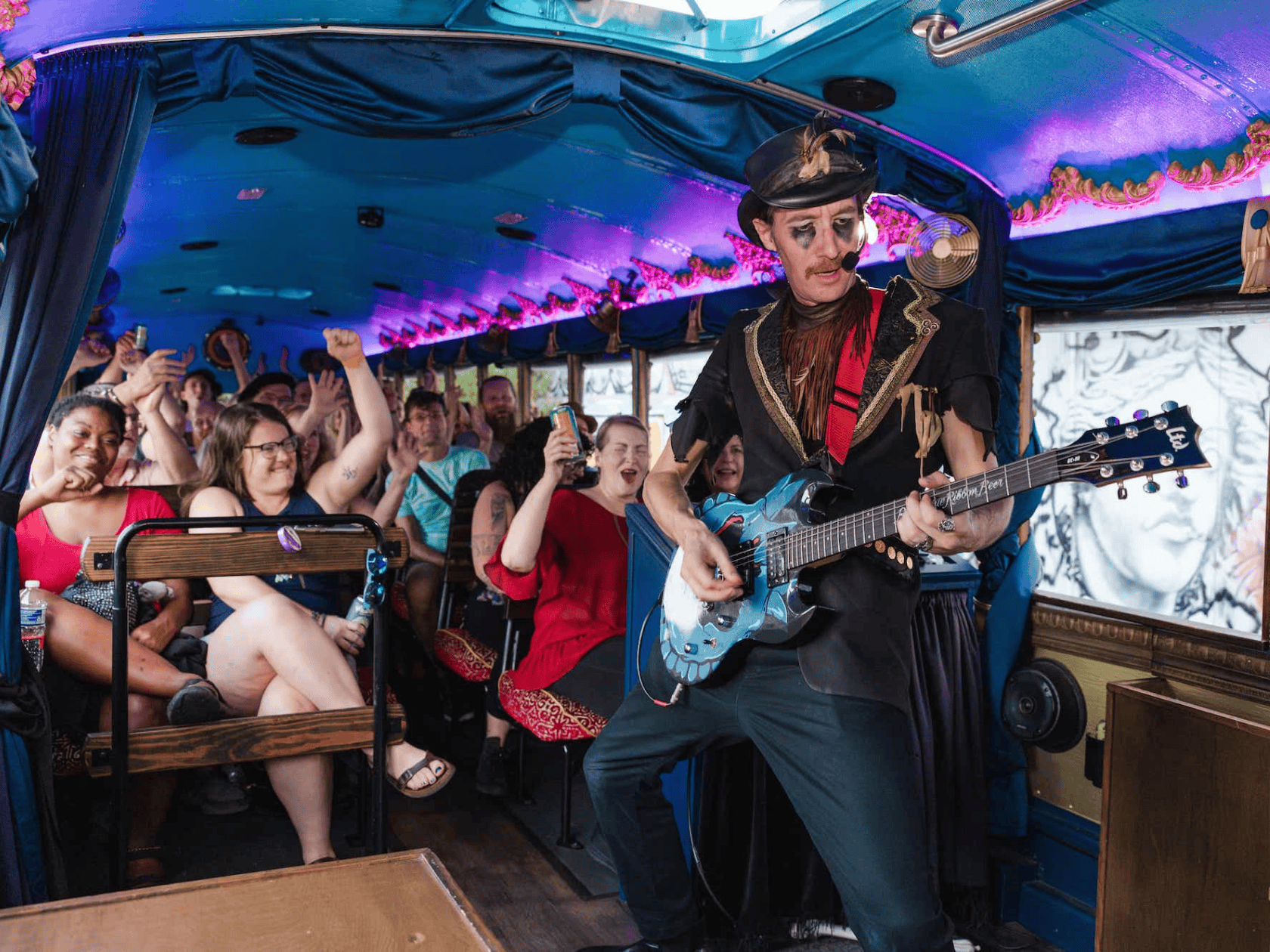 A trolly conductor shredding an electric guitar with a skull face paint